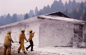 Firefighters spray foam